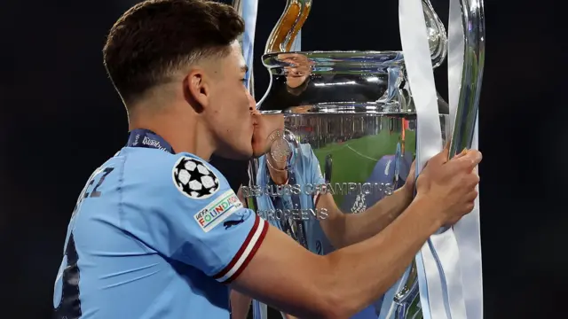 Julian Alvarez kisses the Champions League trophy