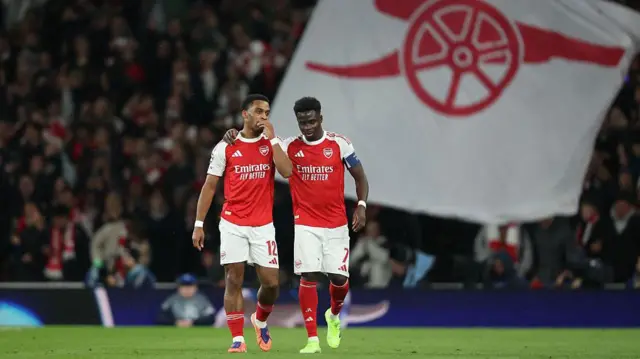 Arsenal's Jurrien Timber in discussion with Bukayo Saka after scoring his side's first goal against Bayern Munich