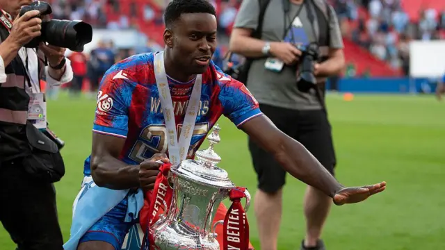 Marc Guehi holds the FA Cup trophy