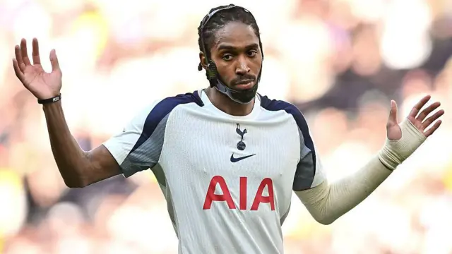 Djed Spence of Tottenham Hotspur gestures