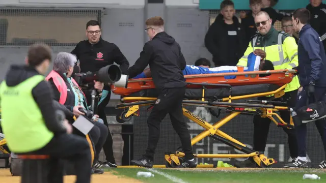 Colchester's Micah Mbick left the match on a stretcher during their League Two game against Newport County