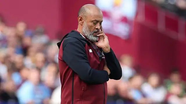 Nuno Espirito Santo with his eyes closed and hand on his chin in disappoitned reflection