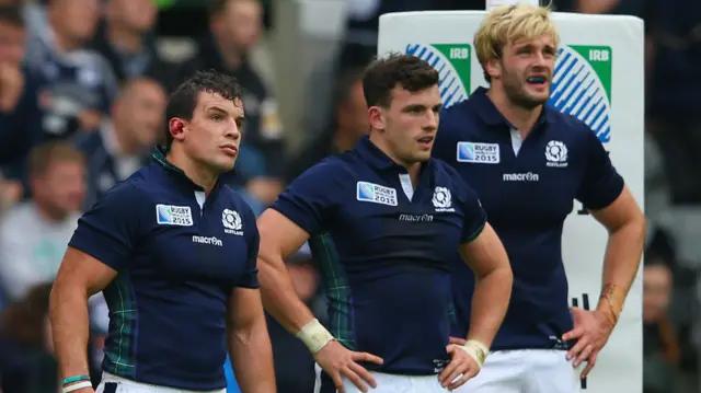 Scottish players look on