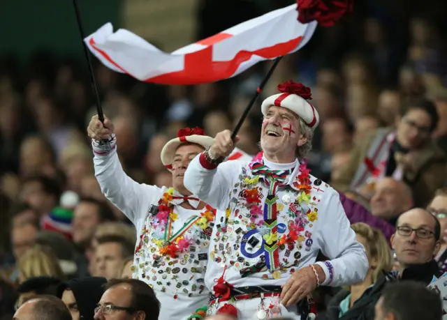 England fans in the crowd wave flags