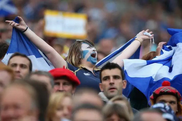 A Scotland fan cheers on the team