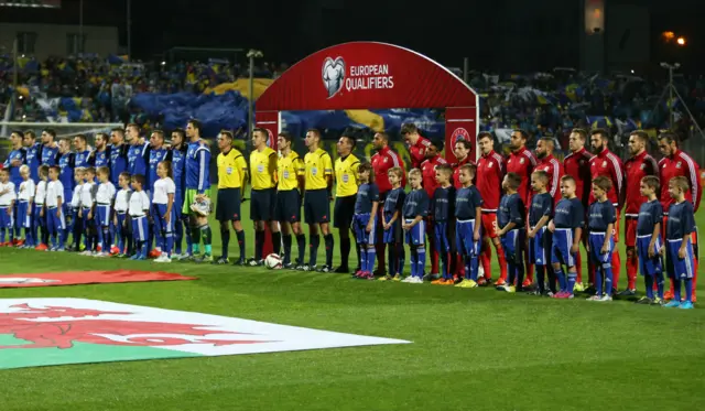 The teams line up ahead of kick off