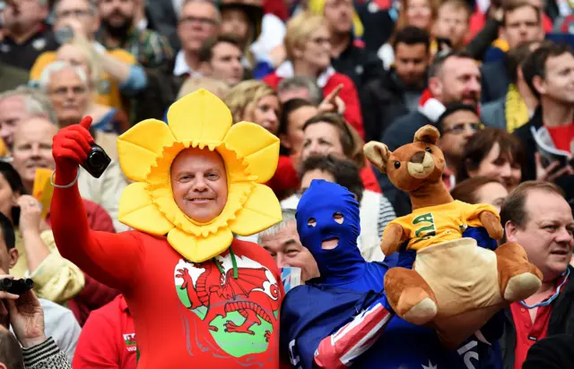 A Wales and Australia fan stand side-by-side