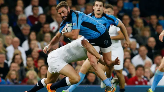 Santiago Gibernau of Uruguay gets tackled