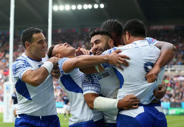 Leiataua of Samoa celebrates scoring a try