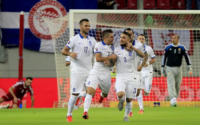 Greece celebrate the opening goal