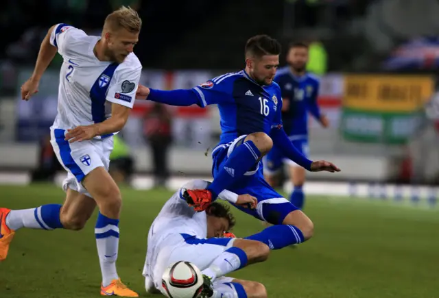 Oliver Norwood is tackled by a Finnish player