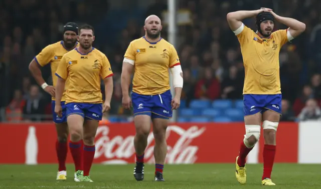 Romanian players stand dejected