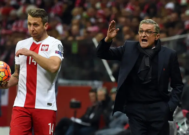 The Polish manager shouts instructions from the touchline