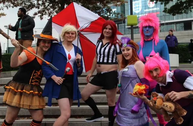 Cosplayers pose outside Wembley