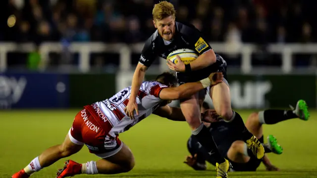 Tom Catterick of Newcastle is tackled