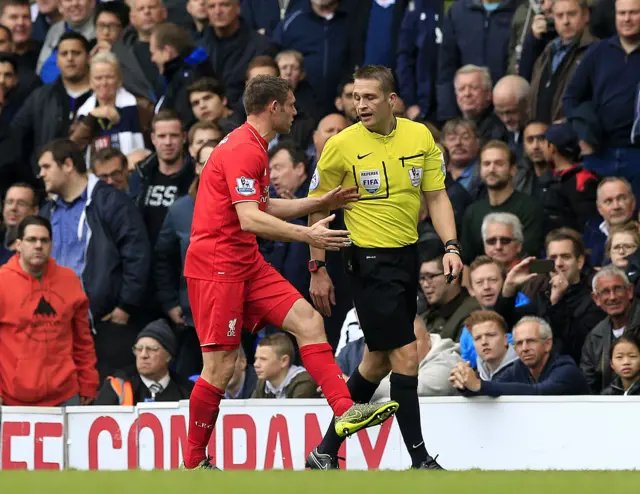 James Milner remonstrates with the referee