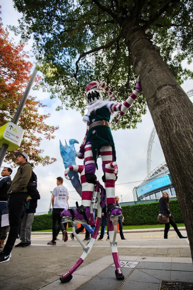 A cosplayer on stilts