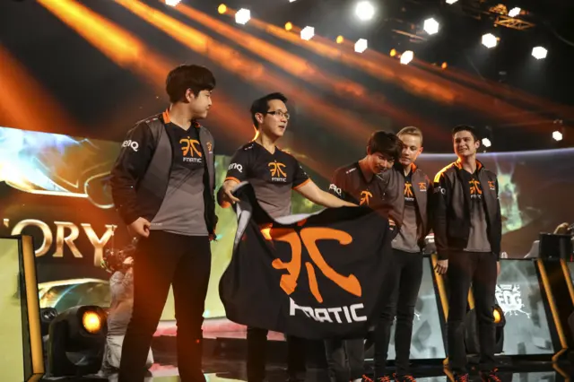 Esports team Fnatic on stage with their banner