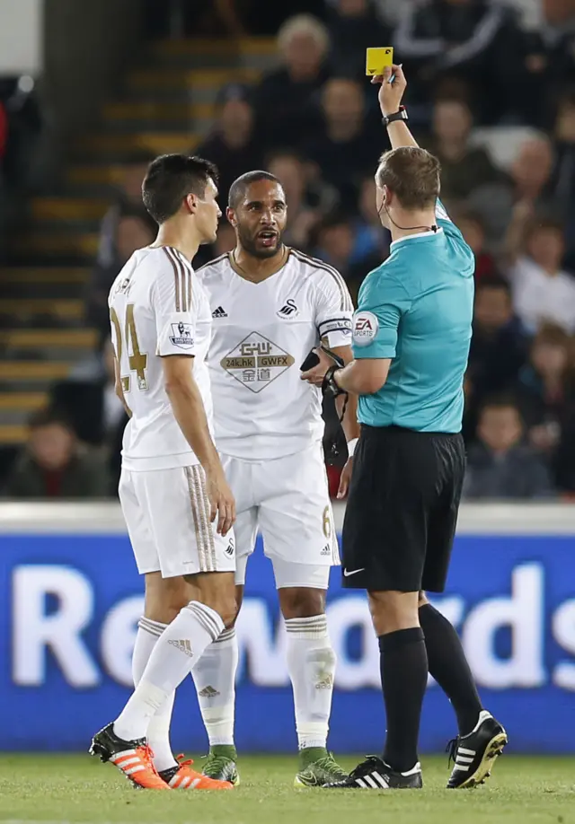 Ashley Williams is shown a yellow card