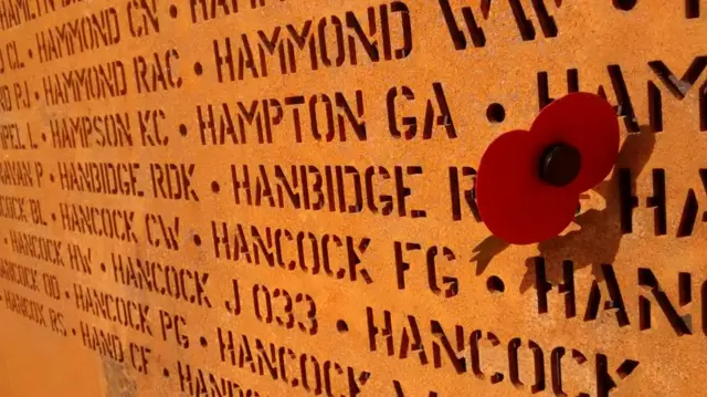 A close up of the names engraved on the memorial