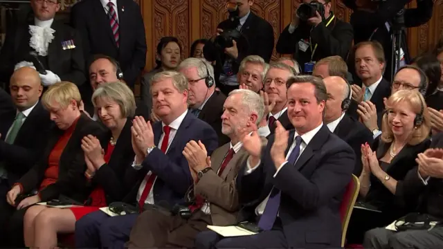 The UK parliamentarians clap after the president's speech