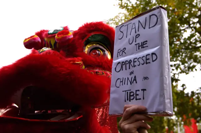 A Chinese dragon and protest sign