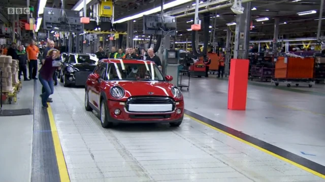 Kate chases the red mini down the production line as James drives off