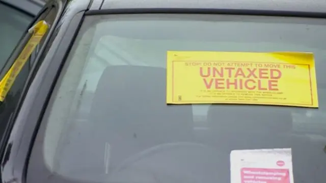 Untaxed vehicle sticker on car windscreen