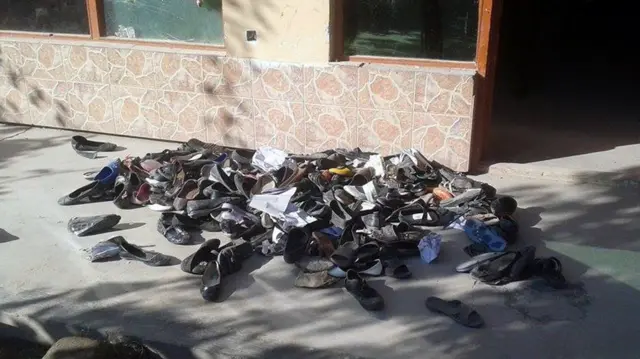 The abandoned shoes of Afghan schoolgirls involved in a deadly stampede are seen outside a school following an earthquake in Takhar Province