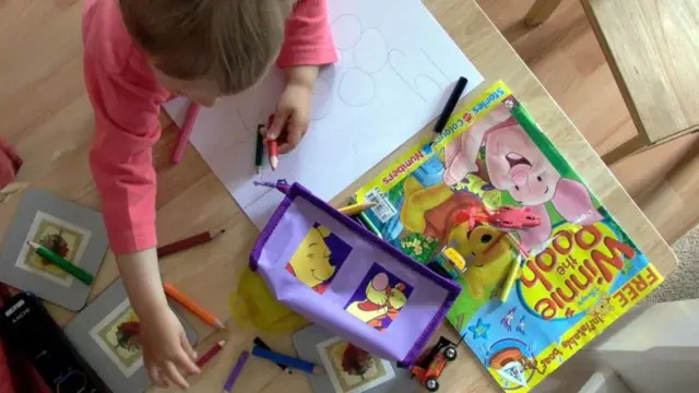 A young child drawing