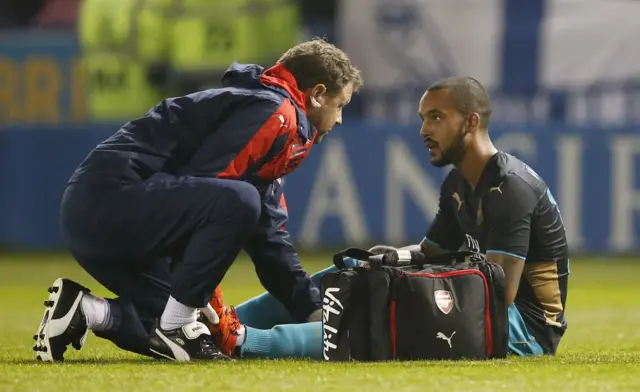 Arsenal's Theo Walcott talks to the physio