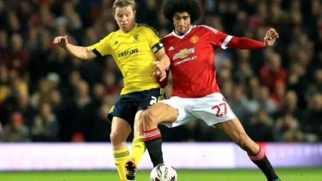 Marouane Fellaini battles for possession