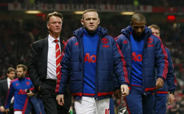 Wayne Rooney walks towards the bench ahead of the match