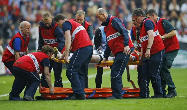 Akihito Yamada of Japan is stretchered off