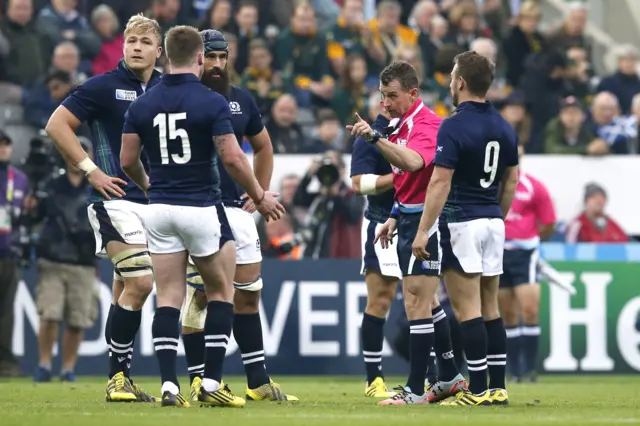 Nigel Owens speaks to Scotland's Stuart Hogg