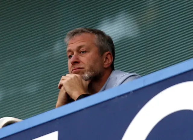 Roman Abramovich looks on