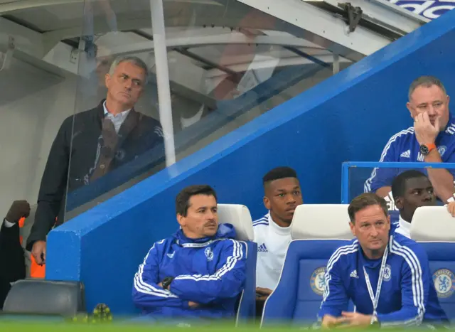 Jose Mourinho stands behind the dug out