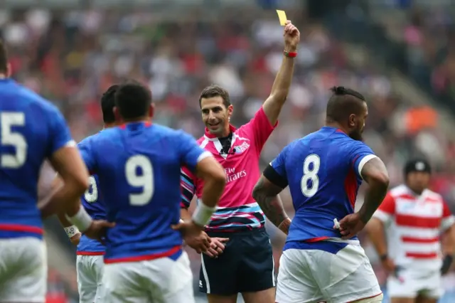 Referee Craig Joubert shows the yellow card to Faifili Levave of Samoa