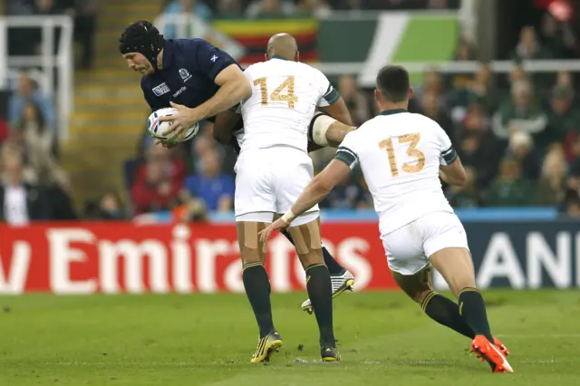 Scotland's Tim Swinson is tackled by JP Pietersen