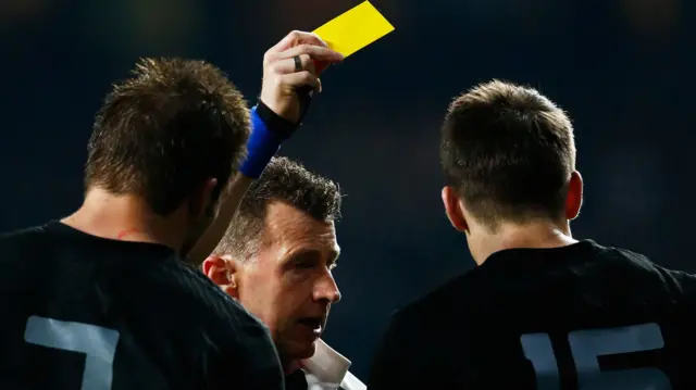 Nigel Owens shows a yellow card