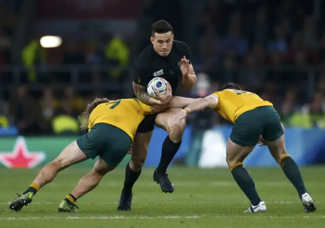 Sonny Bill Williams is tackled by two Australia players