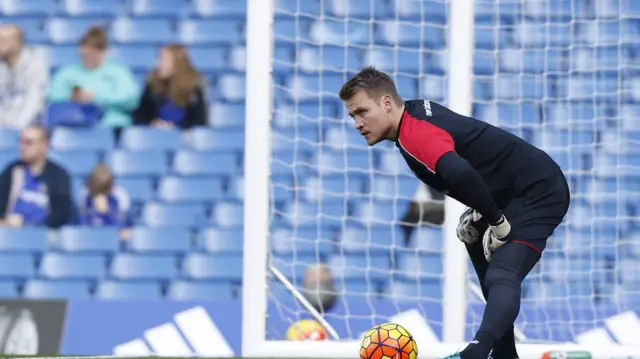 Liverpool goalkeeper Simon Mignolet warms up