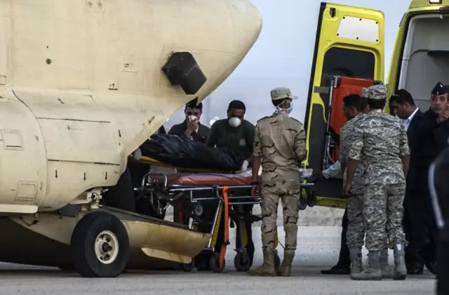 Egyptian paramedics load the corpses of Russian victims of a Russian passenger plane crash in the Sinai Peninsula, into a military plane at Kabret military air base by the Suez Canal on 31 October 2015.