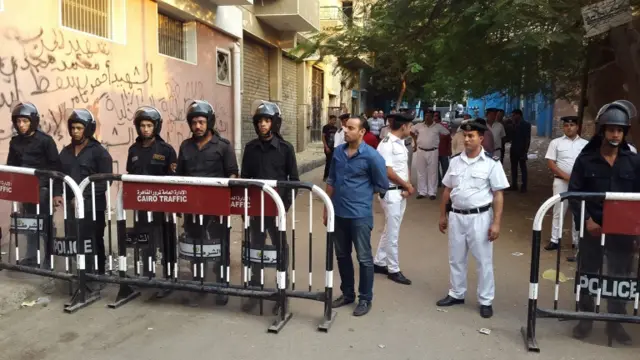 Members of the Egyptian security services stand guard as they await the bodies of the victims of the Russian passenger flight crash, Zeinhom morgue, Cairo, Egypt, 31 October 2015.