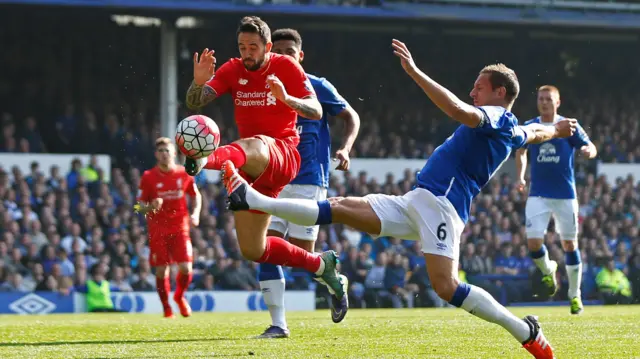 Liverpool's Danny Ings in action with Everton's Phil Jagielka