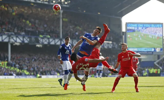 Emre Can in action with Everton's Gareth Barry