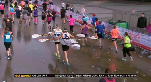 Runners carrying a canoe