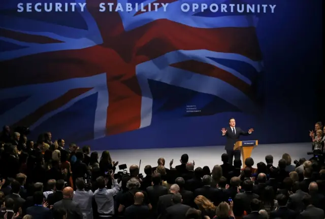 David Cameron arrives on stage to deliver his conference speech