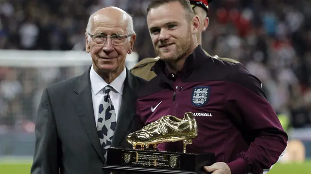 Wayne Rooney collects his award for scoring 50 goals for England