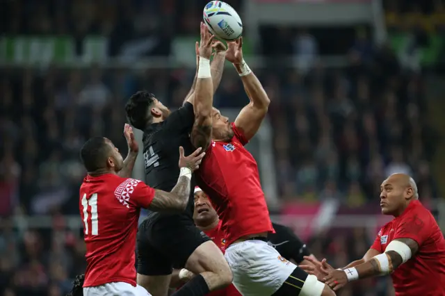 Tonga and New Zealand players compete for the ball